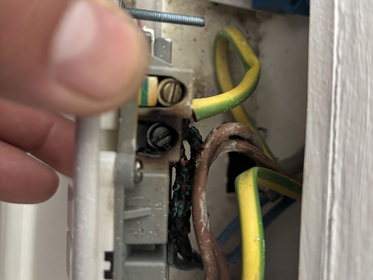 Close-up of scorched socket terminals and wiring