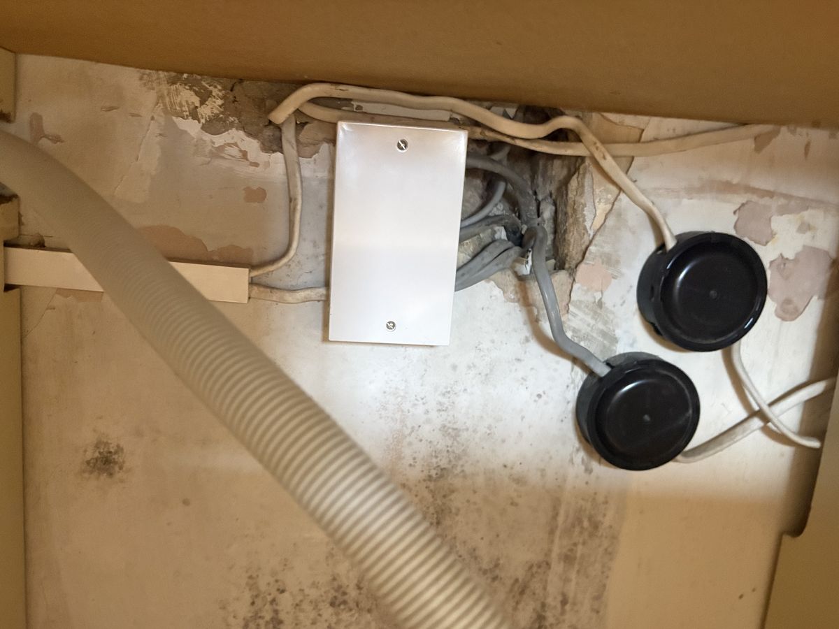 Junction boxes and cables under a kitchen sink